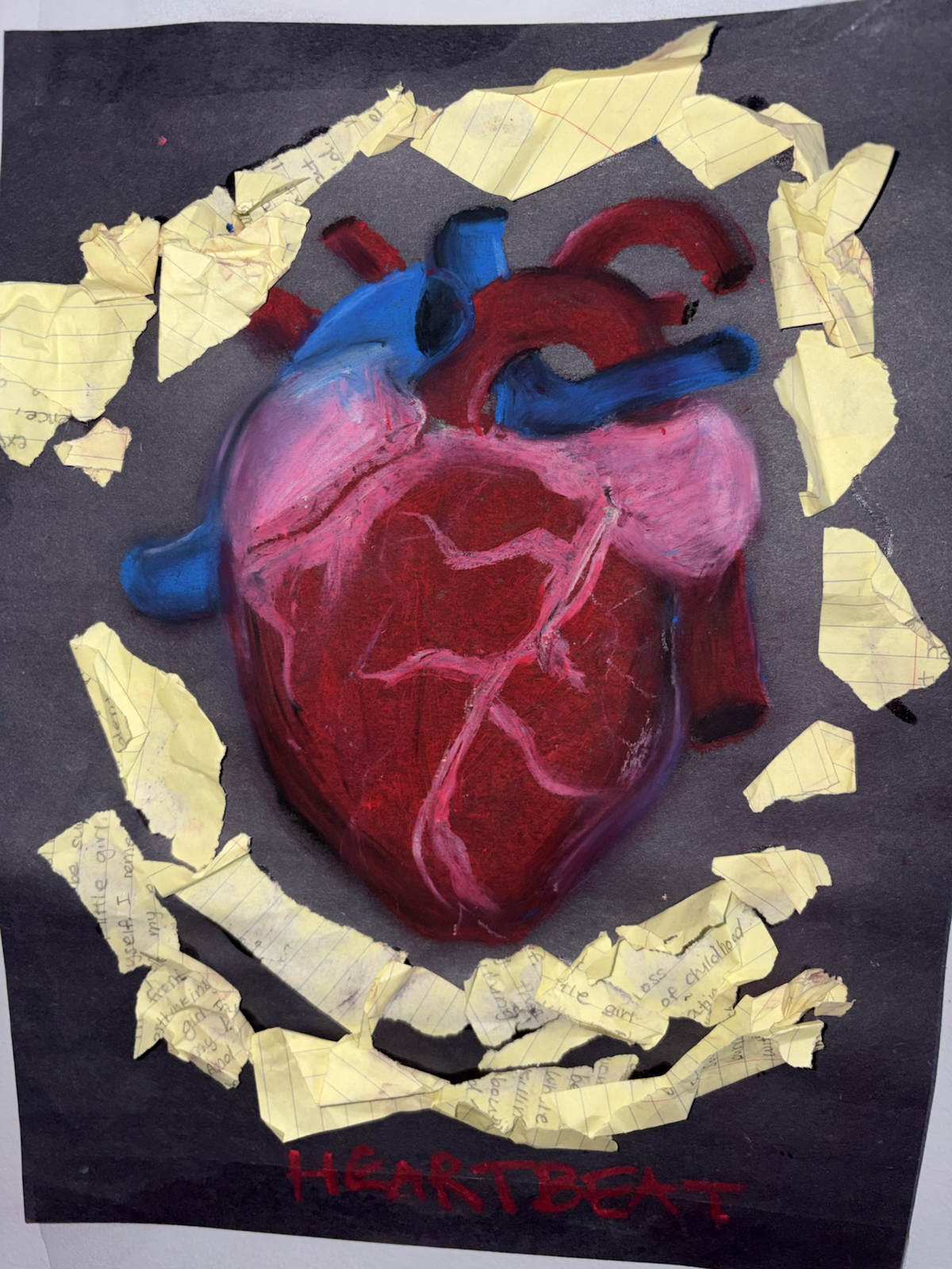 A painted anatomical heart surrounded by torn handwritten notes